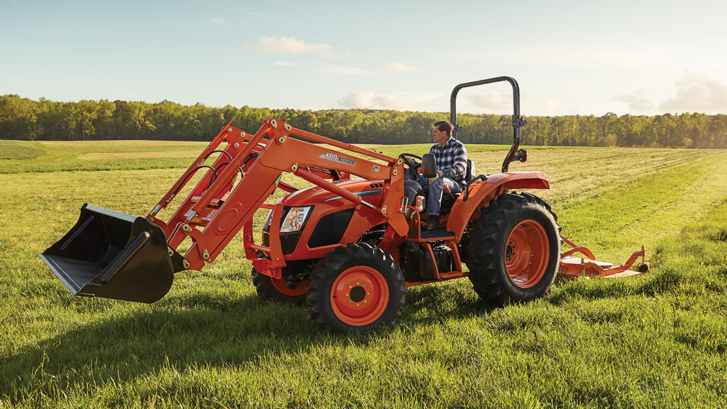 kioti tractor mowing a field